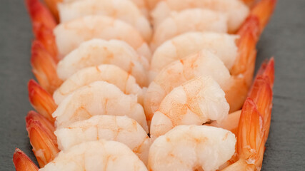 fresh shrimps close up on black plate