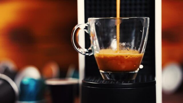 Automatic coffee machine with coffee capsules or coffee pods pouring espresso drink