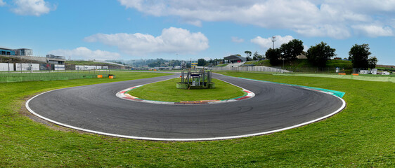 Hairpin bend turn in motorsport asphalt circuit scenic wide panoramic view