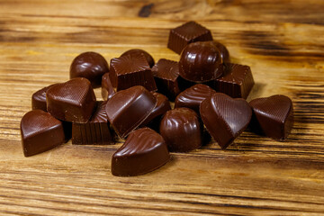 Tasty chocolate candies on wooden table