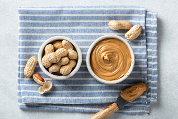 peanut butter in a ceramic bowl on a light background, top view