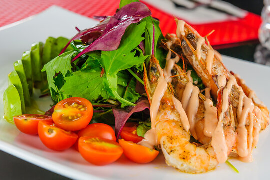 Tiger shrimps salad with avocado and latuce.