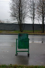 trash can on the wet sidewalk