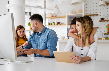 Business parents interrupts by her children while working in home office