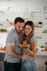 Husband's birthday. Wife surprise her husband with birthday cake