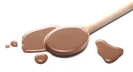 Chocolate milk puddle with wooden spoon isolated on white background