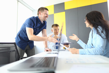 Business partners sit at table and discuss workflow. Small and medium business development concept