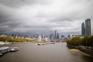 The River Thames with a cloudy skyline and cityscape as the background