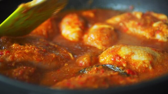 Indian chicken tikka masala spicy curry meat food in cast iron and spices. Grilling Ayam Bakar traditional Indonesian food