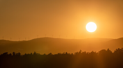 Dramatic silhouette sunset over Lavanttaler Alps in Styria.