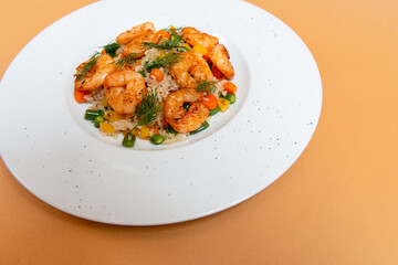 fried shrimp with vegetables and rice on white plate. beige background. top view. flat lay.