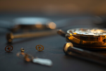 Mechanical watch assembly, watchmaker's workshop with many parts and gears