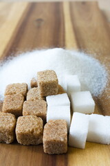 Cube of sugar on wooden table