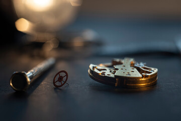 Mechanical watch assembly, watchmaker's workshop with many parts and gears