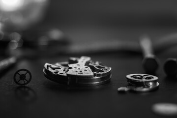 Mechanical watch assembly, watchmaker's workshop with many parts and gears