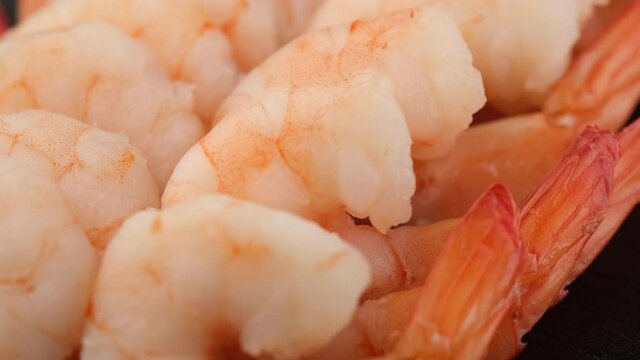 fresh shrimps close up on black plate