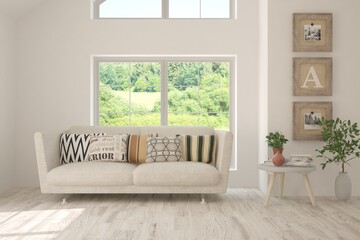 White living room with sofa and summer landscape in window. Scandinavian interior design. 3D illustration