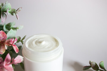white rectangular box with shadows on a light white background. White plastic cream jar. For cosmetics or cosmetology background. stand for advertising beauty products. 