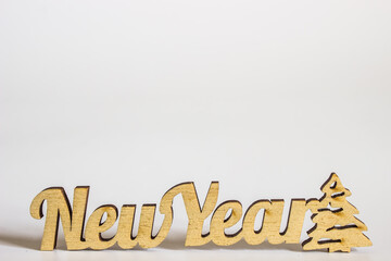 wooden inscription new year on a white background in a minimalist style. place for text and design