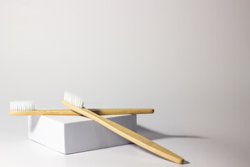 bamboo wooden toothbrushes on white background with stand and craft glass. care for ecology and the environment. hygiene.