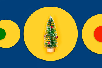 Christmas and New year yellow and classic blue background with Christmas tree and colored circles. Flat lay, top view, copy space.