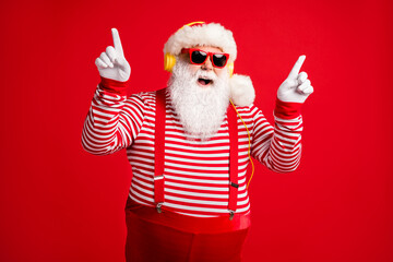 Fototapeta na wymiar Portrait of his he handsome bearded fat overweight cheerful funny Santa listen single hit sound stereo rest chill leisure dancing having fun isolated bright vivid shine vibrant red color background