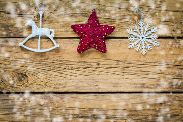 Festive background with vintage Christmas ornaments on a wooden board.