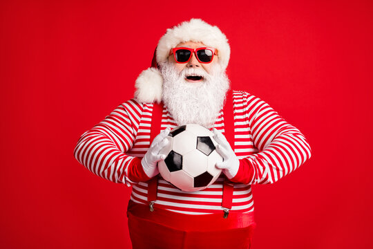 Portrait of his he nice handsome attractive cheerful cheery glad Santa grandfather holding in hands throwing ball playing match isolated bright vivid shine vibrant red color background
