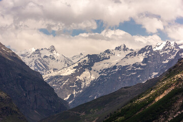 Fototapeta premium Scenic landscape of a snow capped Himalayan mountain range in the Lahaul district in the state of Himachal Pradesh in India.