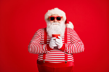 Fototapeta na wymiar Portrait of his he nice handsome attractive cheery confident thick Santa father drinking eggnog cacao rest relax pause break isolated bright vivid shine vibrant red color background