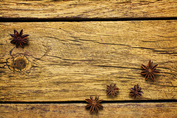 Christmas background with star anise on a wooden board.