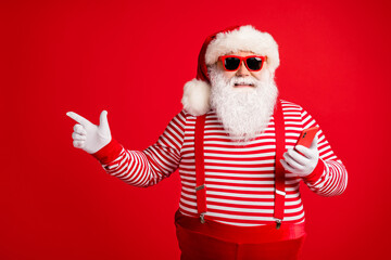 Fototapeta na wymiar Portrait of his he nice handsome cheerful bearded fat overweight Santa using device app 5g showing copy space shopping gift present surprise isolated bright vivid shine vibrant red color background