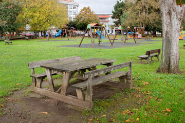 A wooden picnic table in a lonely playground
