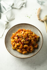 Pasta with tomato sauce and salami