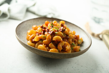 Pasta with tomato sauce and salami