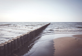 Row of wooden logs at the beach of Sianozety, Poland