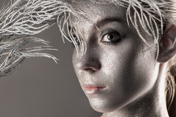 beautiful woman face with silver powder closeup