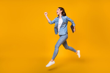 Fototapeta na wymiar Full length body size view of her she nice attractive slim fit cheerful successful girl jumping running carrying laptop late work isolated bright vivid shine vibrant yellow color background