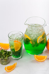 Side view on lemonade in a jug and glass
