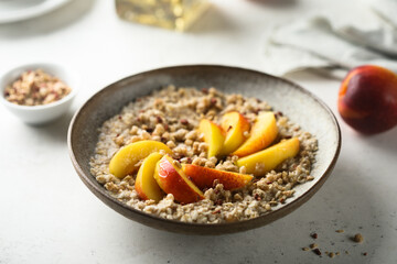 Healthy oatmeal porridge with fresh peach