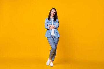 Fototapeta na wymiar Full length photo of attractive confident young business lady arms crossed good mood professional freelancer beaming smile wear casual denim shirt isolated vivid yellow color background