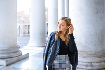 The portrait of a blonde teen girl walking in the city, visit a museum