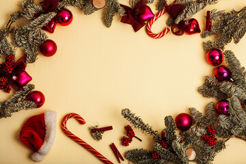 christmass stuff laying flat on colorful background, branch of tree, balls, candy