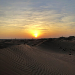 Obraz na płótnie Canvas Sunset during a deset travel in Abu Dhabi