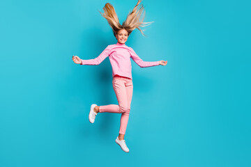 Full size photo of funny positive teenager jump hair up wear pink pants poloneck white footwear isolated on teal background