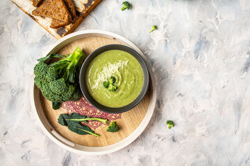 Fresh vegetable detox soup made of broccoli with parmesan and crispy croutons. Clean eating, dieting, vegan, vegetarian, healthy food concept, top view