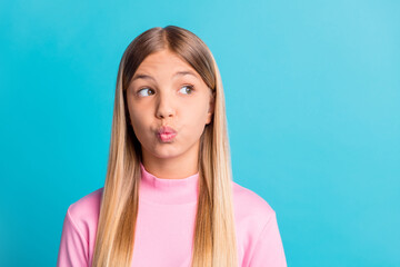 Photo portrait of dreamy schoolgirl with blonde hair sending air kiss looking at copyspace isolated...