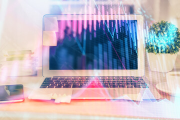 Financial market graph hologram and personal computer on background. Double exposure. Concept of forex.