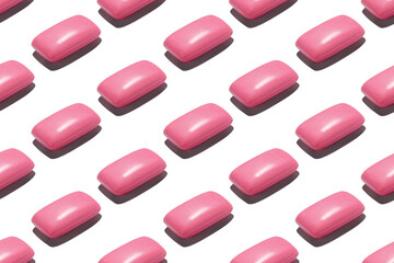 Seamless repetitive pattern with pink soap bars on white background.