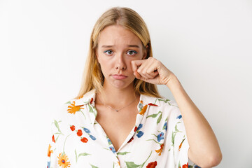 Unhappy beautiful girl crying while posing at camera